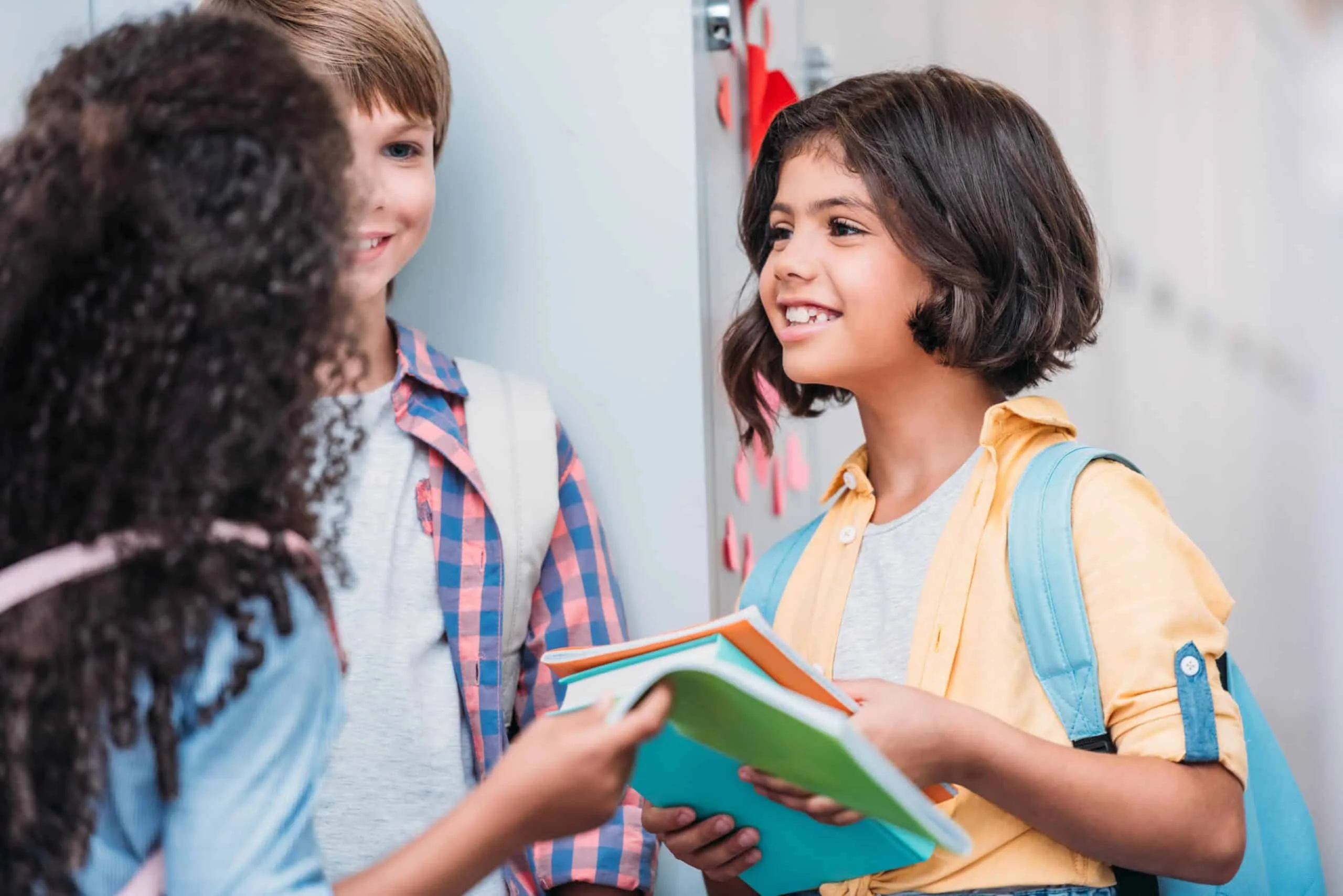 pupils talking in school next to school lockers 1 min min min scaled 1
